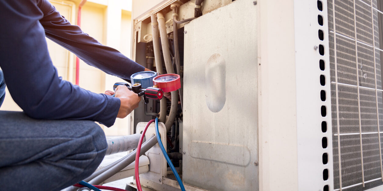Technician is checking air conditioner ,measuring equipment for filling air conditioners.