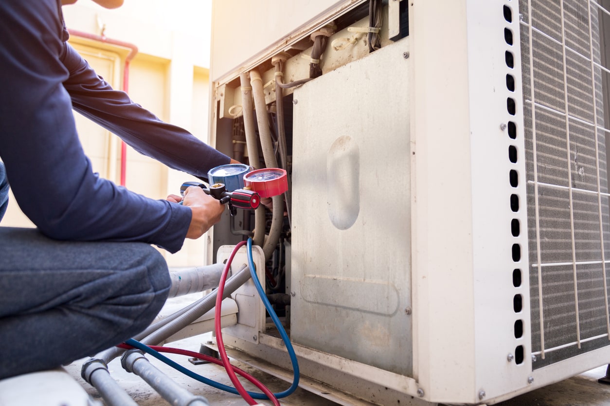 Technician is checking air conditioner ,measuring equipment for filling air conditioners.